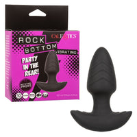 tapered rotating anal plug with ridges, and bottom base, beside box packaging 