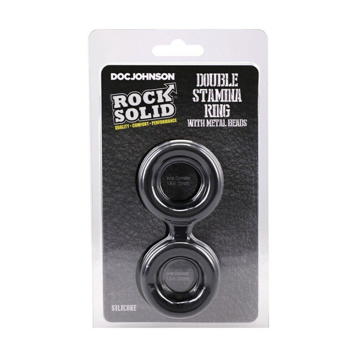Packaged double stamina cock ring with metal beads on a white background