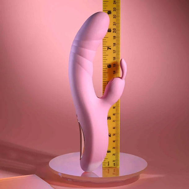 Pink rub me right vibrator with a yellow measuring tape on a pink background