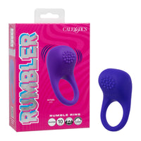 A purple silicone rumbler ring shown next to its pink retail packaging box. The box features the brand name 'CAL EXOTICS' and the product name 'RUMBLER'.