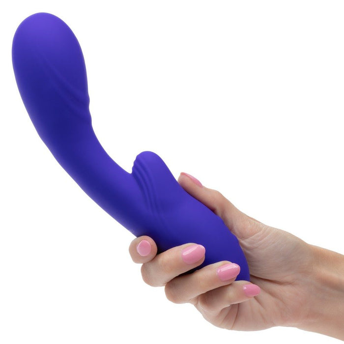 Purple rumbler rumble g vibrator held by a hand on a white background