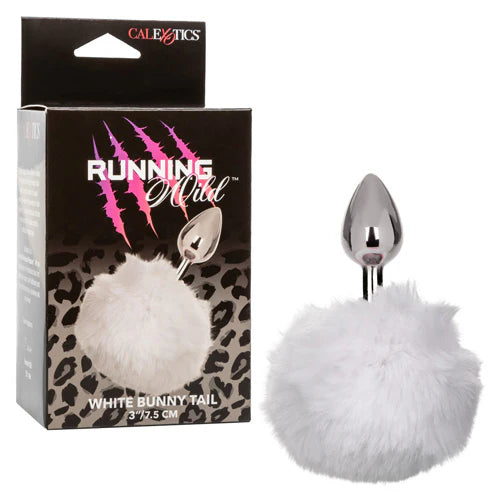 White bunny tail with silver tip butt plug next to its packaging