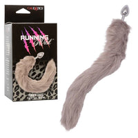 Gray faux fur tail with anal plug next to its packaging
