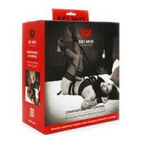 woman laying on bed with neck and feet restraint on box packaging