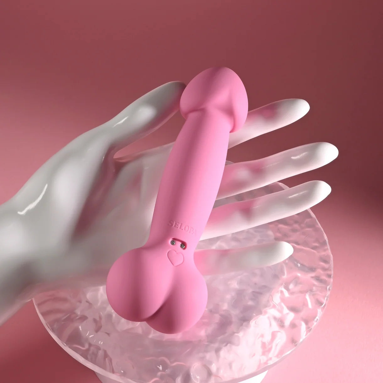 pink penis shaped vibrator held in hand