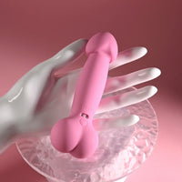 pink penis shaped vibrator held in hand