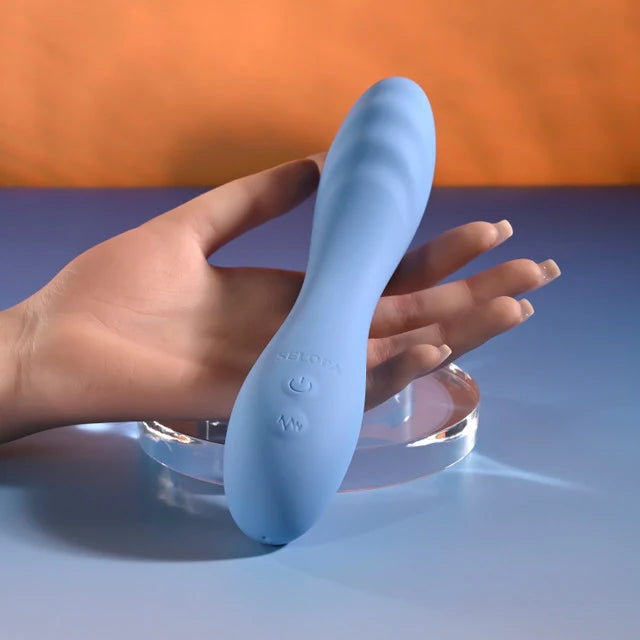 curved blue vibrator held in hand