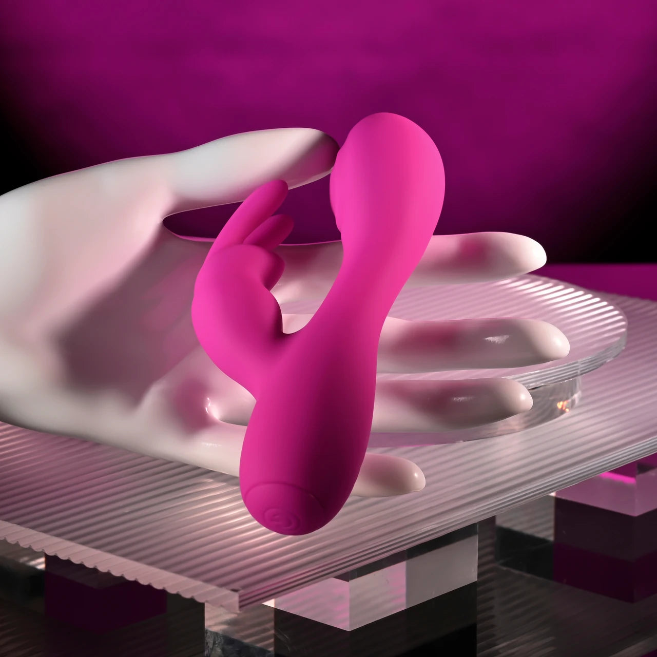 pink vibrator with bunny clitoral stimulator, held in hand