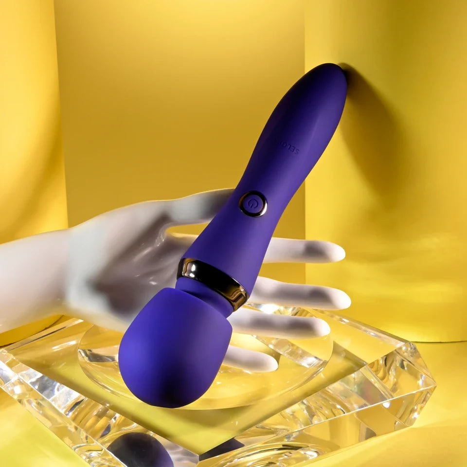 purple wand, held in hand on yellow background