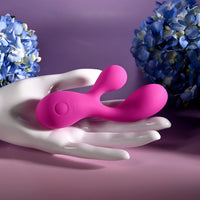 pink vibrator with bulb head and clitoral stimulator in hand