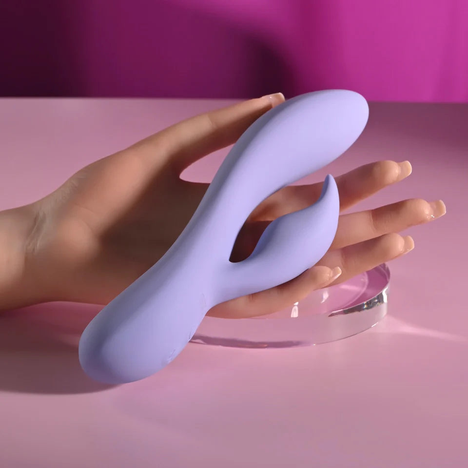 Selopa Purple Craze dual vibrator in purple shown resting in a hand to demonstrate its size and curved design.