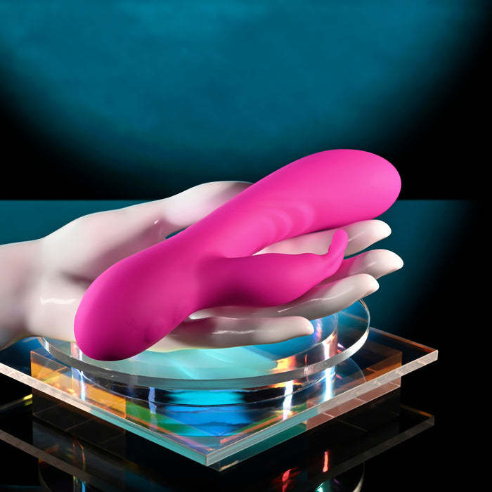 pink vibrator with bunny stimulator held in hand