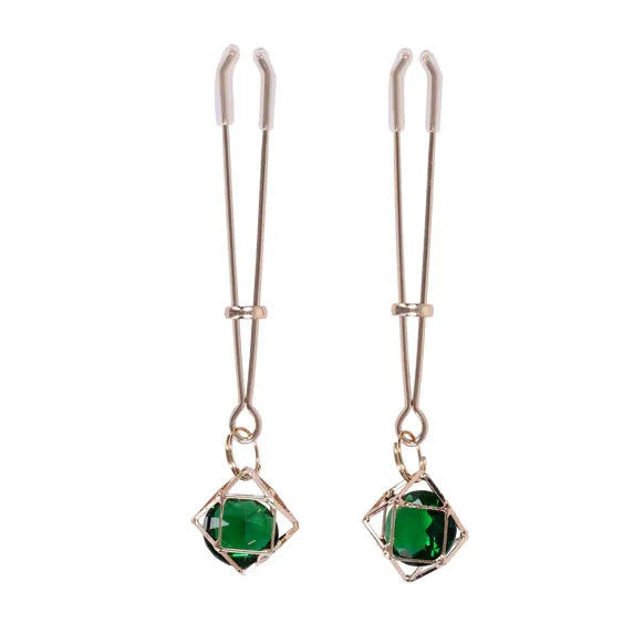 Pair of nipple clamps with green gemstones on a white background