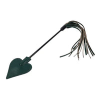 Green leather paddle with leather whip on a white background