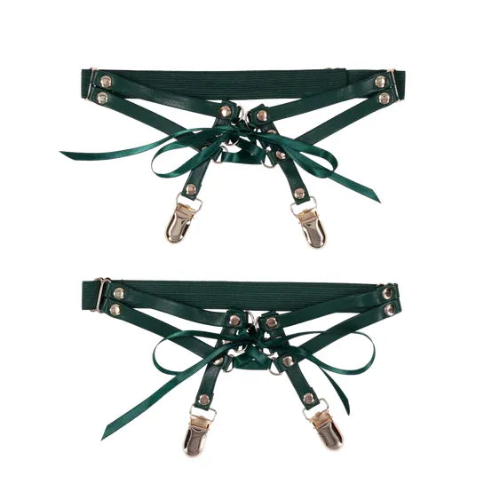 Two green garters with metal clips on a white background