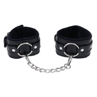 Black leather cuffs with chain on a white background