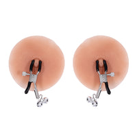 Two silicone breast forms with clamp attachments on a white background