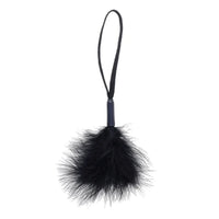 black feathered wrist tickler with a black string on a white background