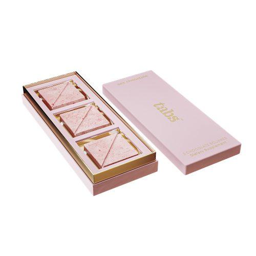 tabs Pink and gold chocolate box with three pieces of chocolate on a white background