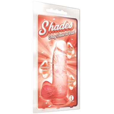 a coral to clear ombre penis shaped dildo with balls and a suction cup, shown in its plastic packaging