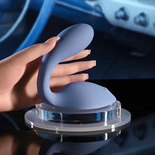 Blue grinder vibrator with a hand holding it against a blurred background