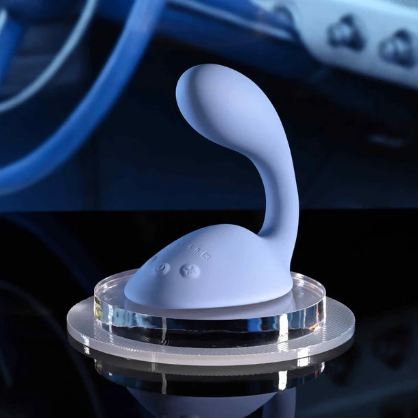 Blue silicone vibrator with grinder pad with a clear base on a dark background