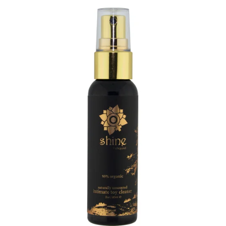 Black bottle with gold cap labeled 'shine' natural toy cleaner on a white background