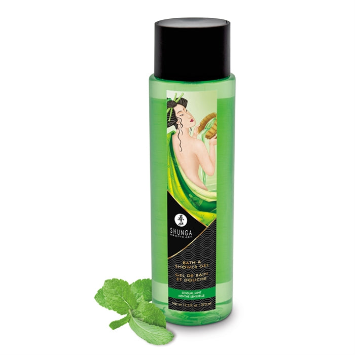 A greem bottle of Shunga Bath & Shower Gel mint with a green label and sensual mint imagery, accompanied by a sprig of mint.