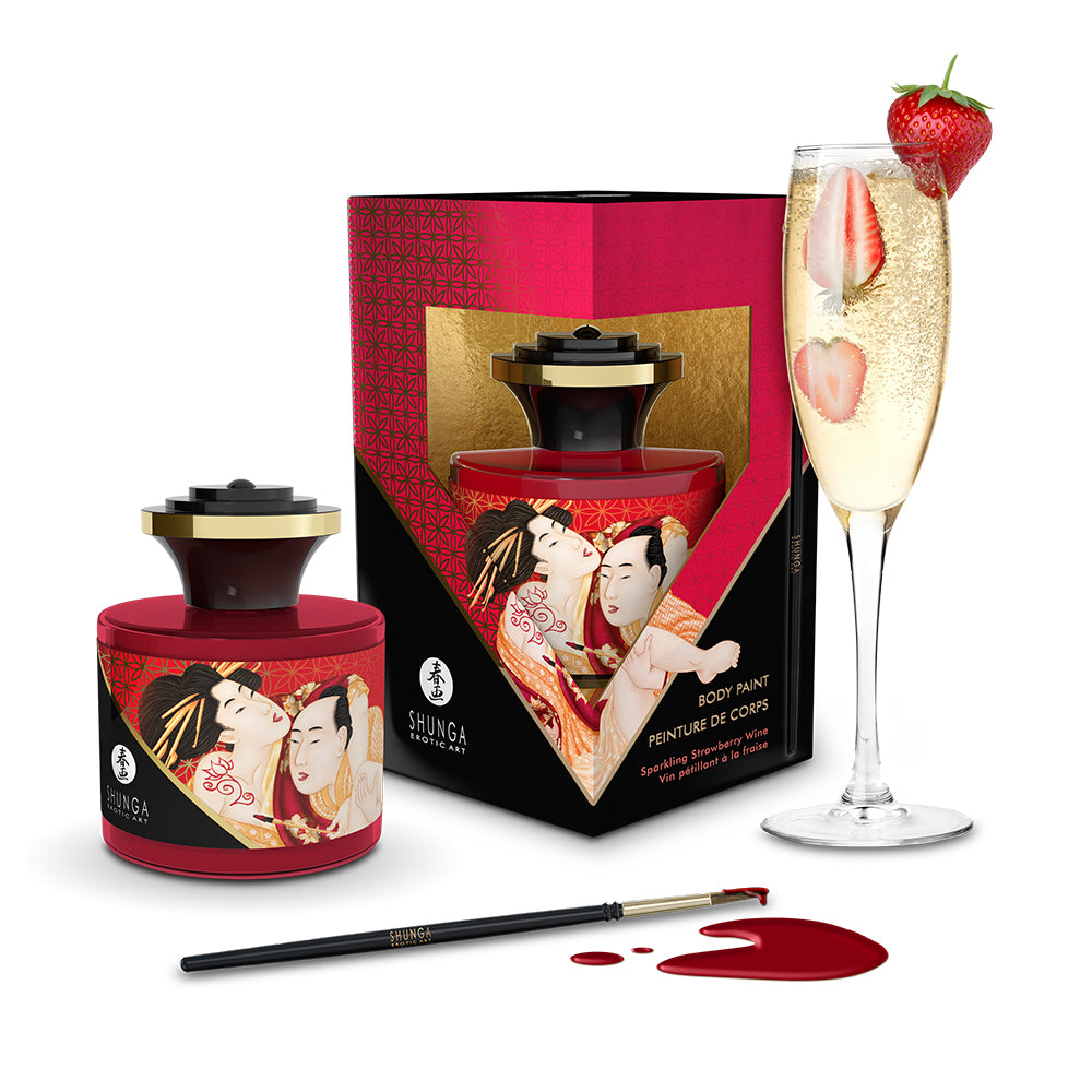 Shunga body paint set with a glass of champagne and strawberry garnish on a white background