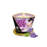 Candle in a decorative container with 'Shunga' branding, featuring an illustration of a couple and lavender flowers on a white background.