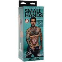 a blue display box depicting a heavily tattooed man in black underwear and jeans