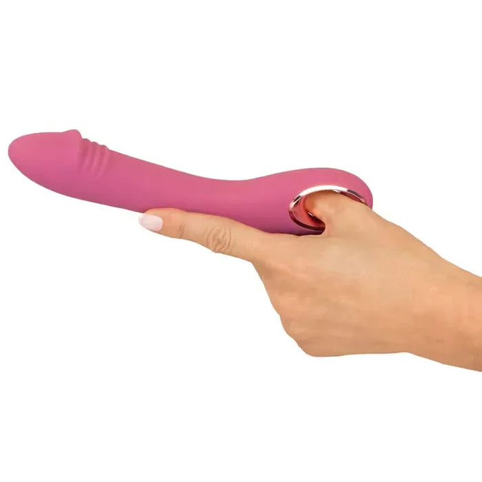 Pink slim g sport rose vibrator held in a hand on a white background