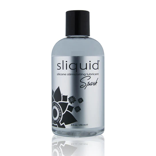 The product comes in a clear bottle with a black cap. It has a silver label with black writing and a black flower design