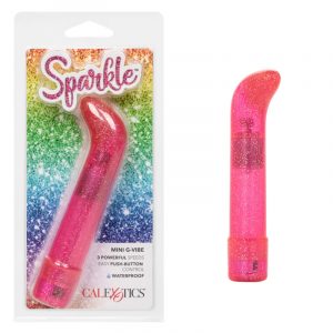 a pink sparkle vibrator with a straight shaft and a curved pointed tip, shown next to its plastic packaging