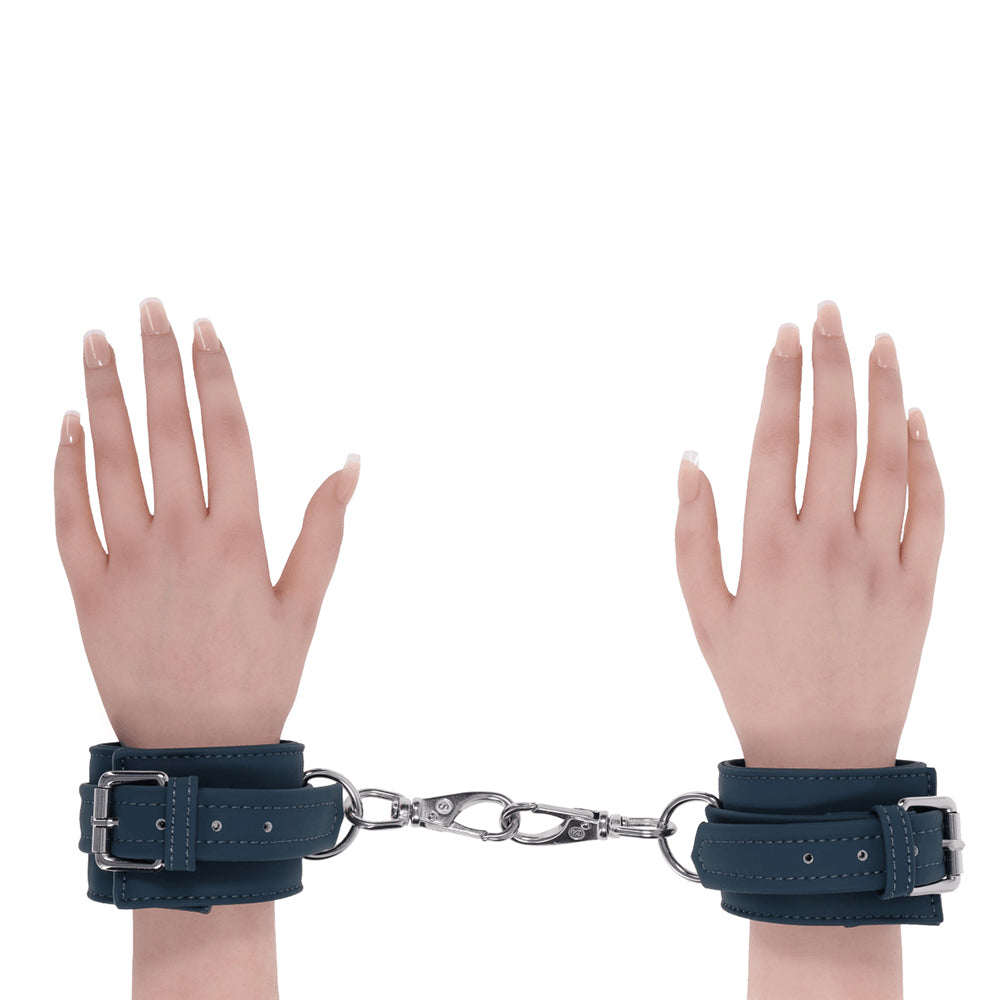 2 hands with green handcuffs on wrists