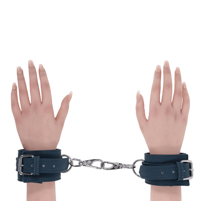 2 hands with green handcuffs on wrists