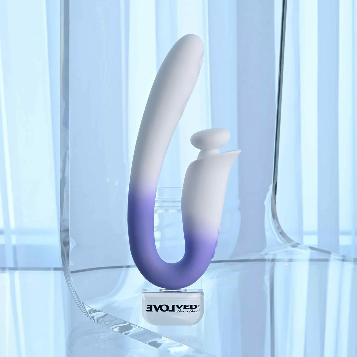 Gradient purple to white vibrator on a reflective surface with 'Evolved' branding.