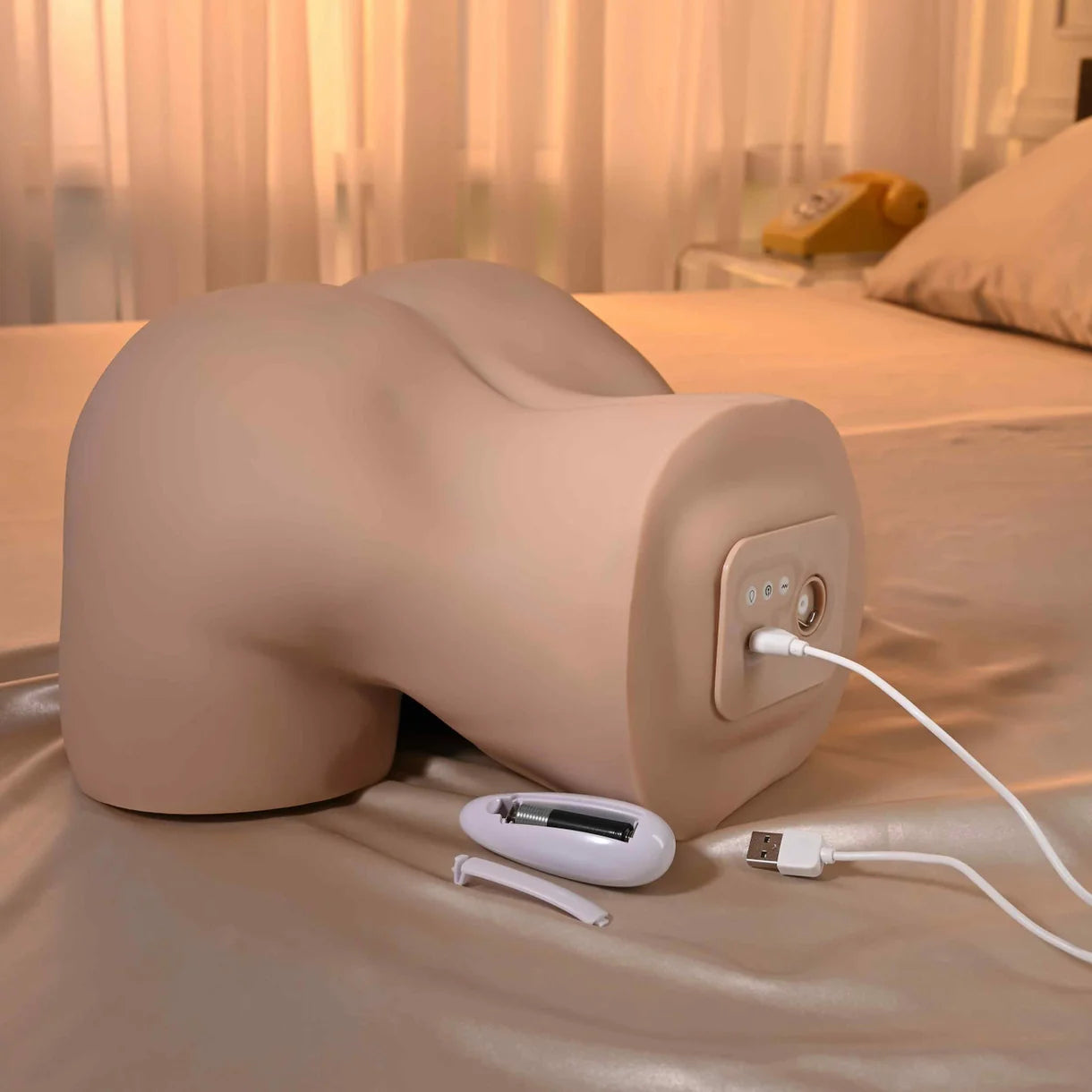 masturbator showing charging option on a bed
