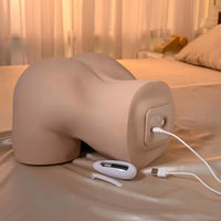masturbator showing charging option on a bed