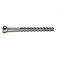 Metallic barbell with spherical ends stainless steel beaded hollow urethral sound with stopper on a white background