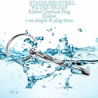 Stainless steel water-proof ribbed urethral plug with water splashes on a white background