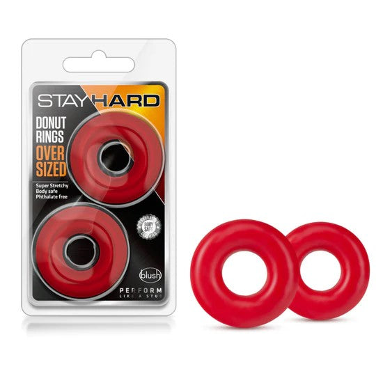 red oversized donut cockrings next to stay hard package