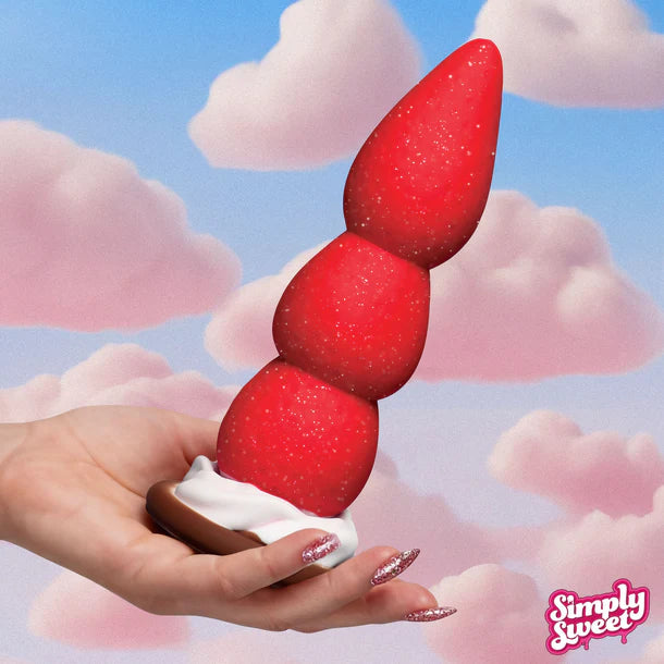 Strawberry dildo held in a hand with a cloud background and 'Simply Sweet' logo.
