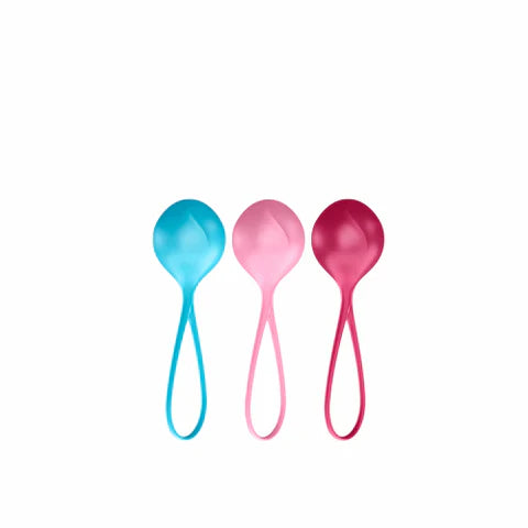 Three colorful Kegel Balls (blue, pink, red) on a white background