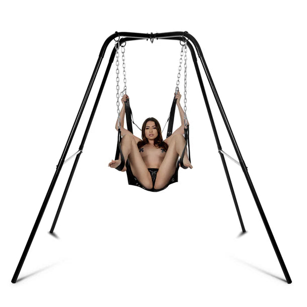 Person using a black swing set on a white background