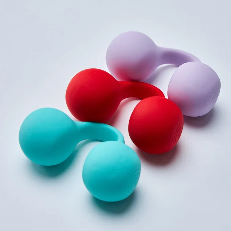 Colorful silicone kegel balls on a light gray background