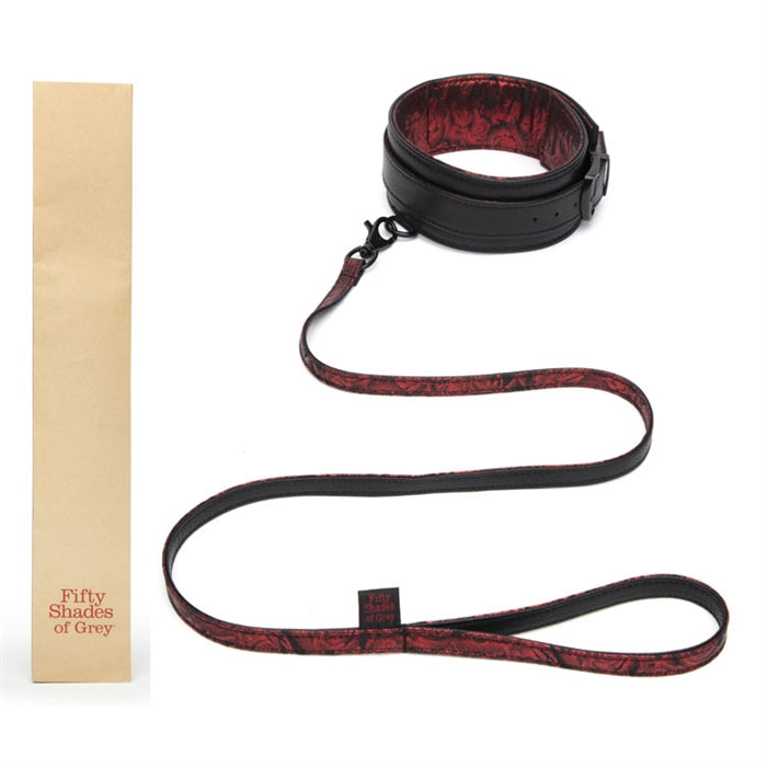 black collar with red lining with black and red leash next to package
