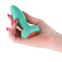 teal vibrating butt plug held in hand