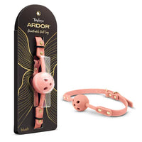 Temptasia Ardor Breathable Ball Gag by Blush in pink silicone with adjustable strap and ventilated gag design, shown alongside retail packaging and angled product view.