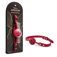 Temptasia Ardor Breathable Ball Gag by Blush in red silicone with adjustable strap and ventilated gag design, shown alongside retail packaging and angled product view.